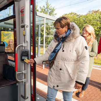Vrouw checkt in met OV-chipkaart Reiziger checkt in met OV-chipkaart